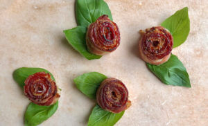 bacon roses with basil leaves