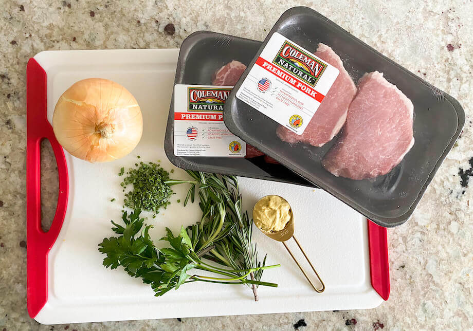 https://www.colemannatural.com/wp-content/uploads/2021/04/Uncooked-pork-chops-on-a-cutting-board-with-other-ingredients-920.jpg