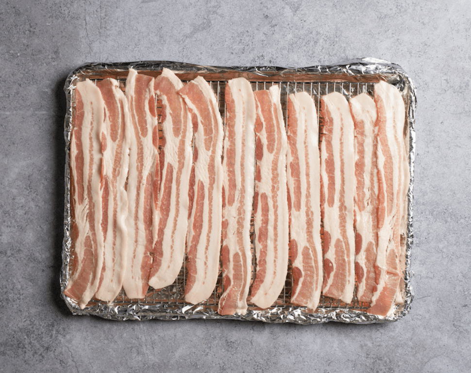 uncooked bacon on a tray