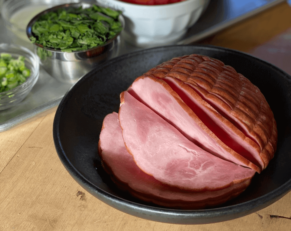 spiral sliced ham in a black bowl