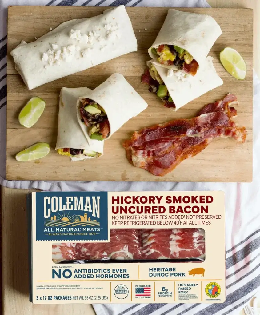 Box of hickory smoked bacon next to tortilla wraps with bacon and vegetables